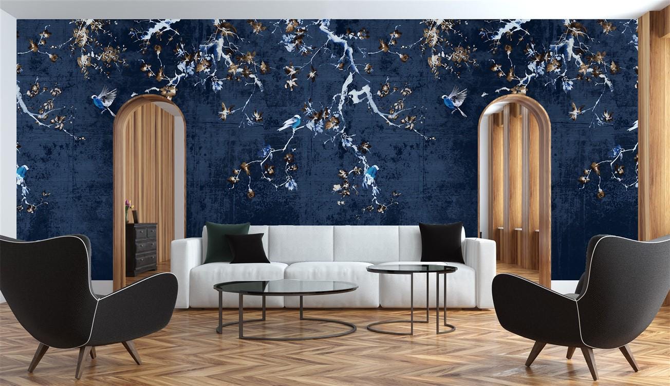 Modern living room with a blue marble wall, white sofa, and black chairs.