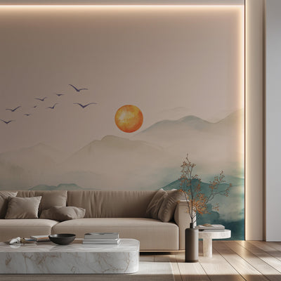 Modern living room with a wall mural of a sunset over mountains and birds.